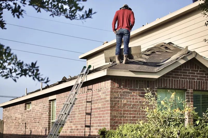 Professional roofer working on a residential roof in Kipling Hills